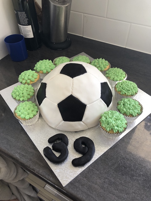 Still a beginner! This was my 3rd cake order! The cake topper and footballs  are sugar cookies also! My question is how much would you charge for  something like this? 3 layer